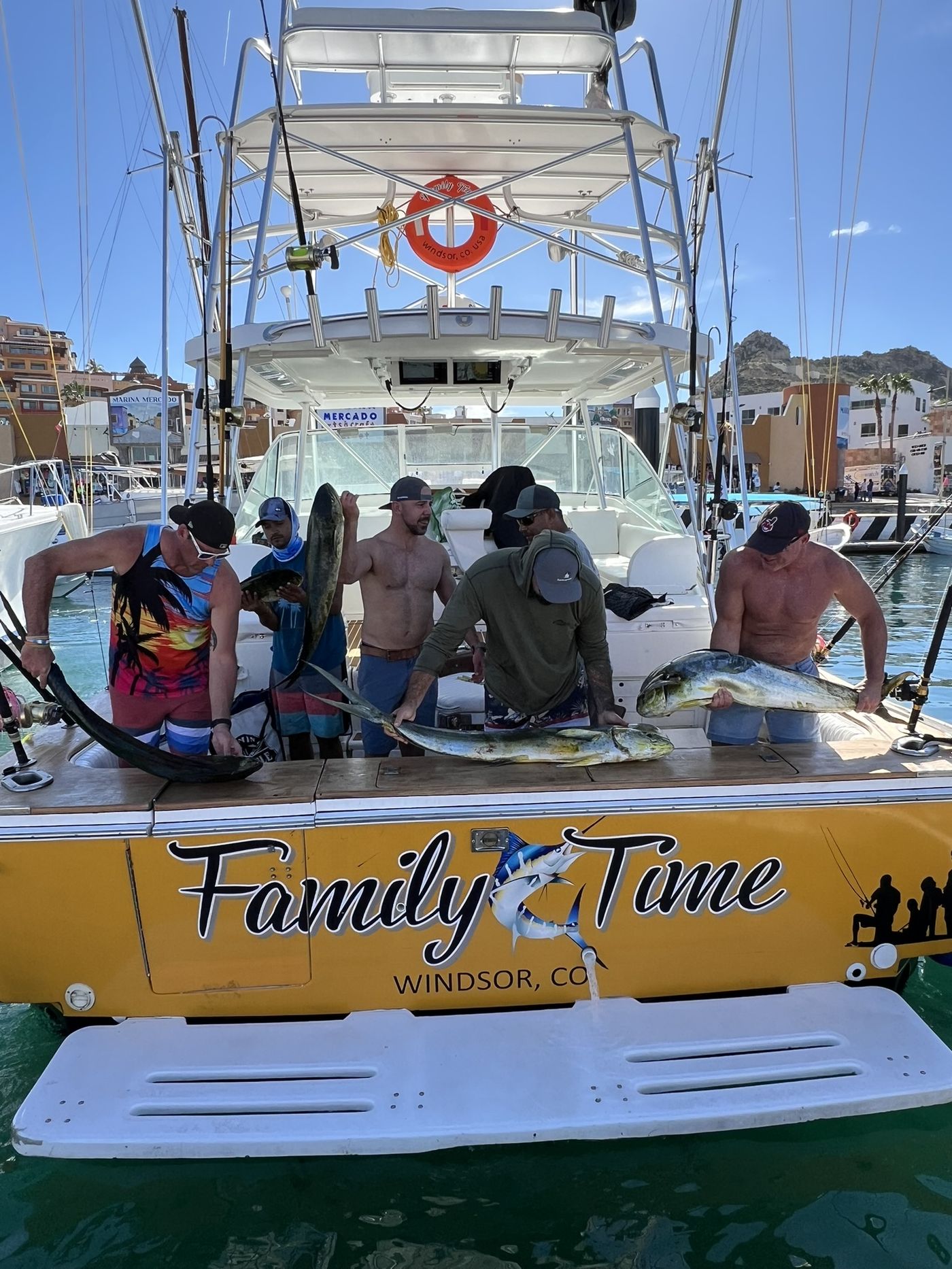 Crew and guests with a dorado each